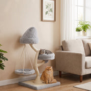 Cat resting on the side bed of the light grey cat tree while a ginger cat sits by the base next to a sofa