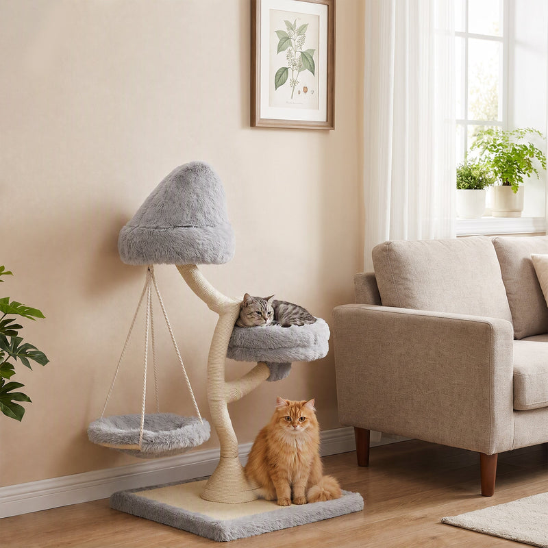 Cat resting on the side bed of the light grey cat tree while a ginger cat sits by the base next to a sofa