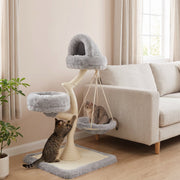 Cat scratching the sisal post while another cat rests in the hammock of the light grey cat tree