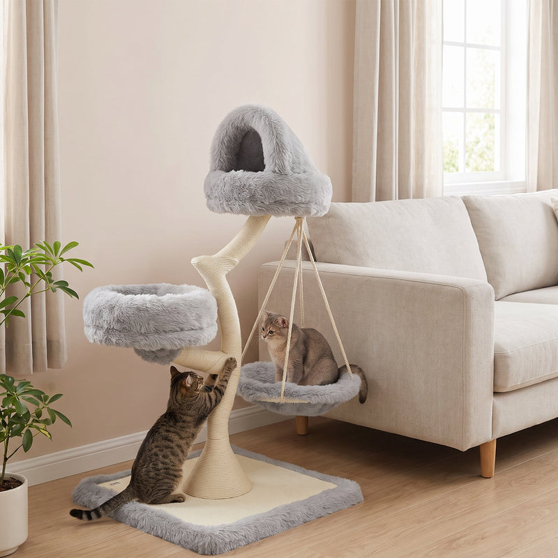 Cat scratching the sisal post while another cat rests in the hammock of the light grey cat tree
