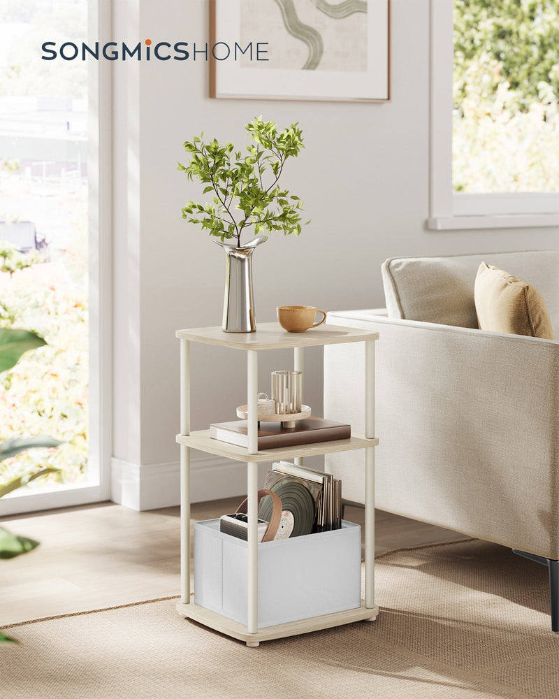 Natural Beige side table styled next to a sofa with a vase, books and a mug on top