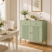 Light green sideboard styled in a dining room beside a table set for a meal