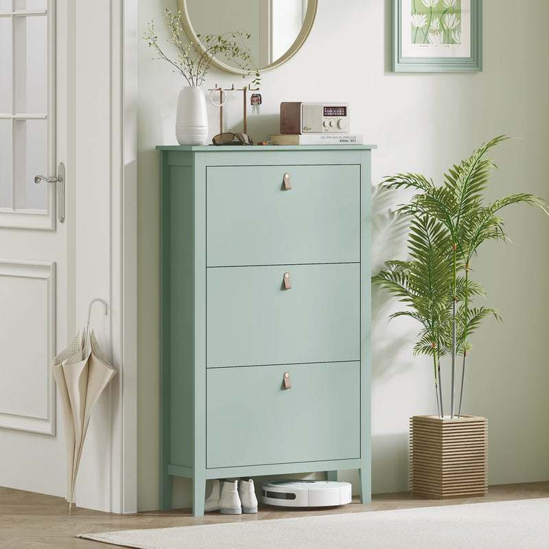 Green shoe cabinet styled in a hallway beneath a round mirror