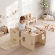 Toddler drawing at the table and chair set in a bedroom with soft toys