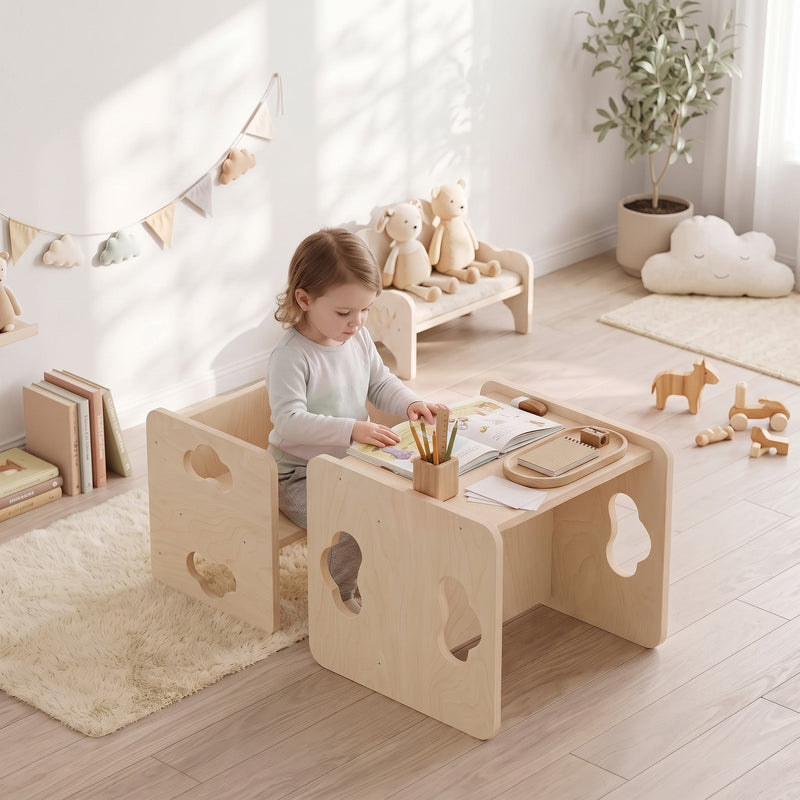 Toddler drawing at the table and chair set in a bedroom with soft toys