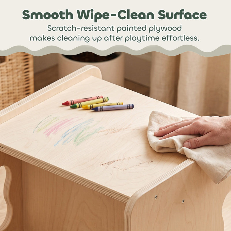 Hand wiping crayon marks off the painted wipe-clean tabletop