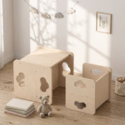 Toddler table and chair set in a bedroom with a teddy bear and books
