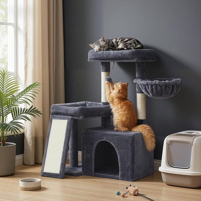 Lifestyle photo of a cat sleeping on the top platform and another climbing the scratching post