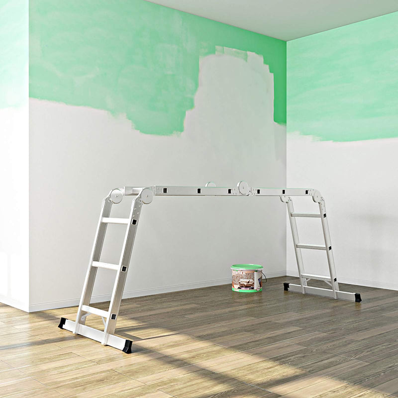 Ladder used as a bridge indoors beside a paint tin while a ceiling is decorated