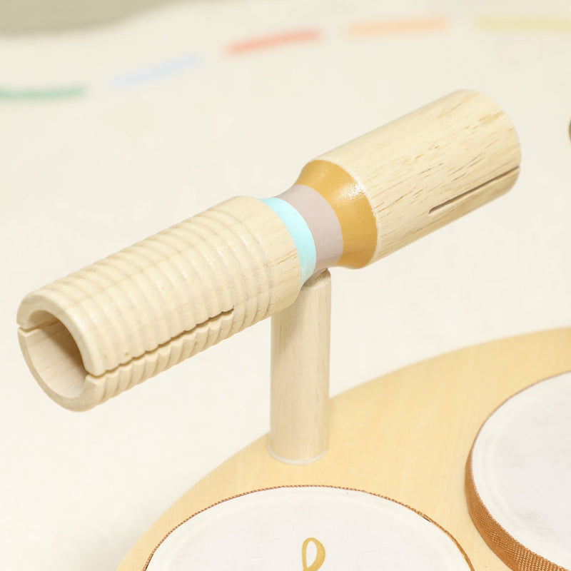 Close-up of the wooden dual-tone block and mallet on the instrument base