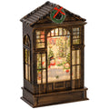Bronze tone snow globe lantern with a snowman scene and wreath on white background