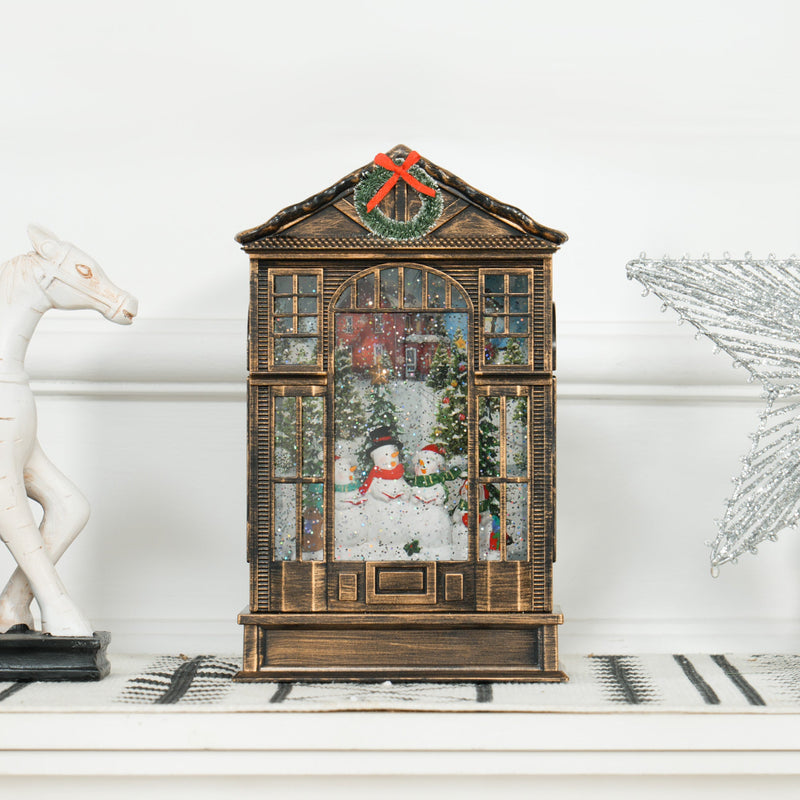 Snow globe lantern on a white shelf beside a white horse ornament