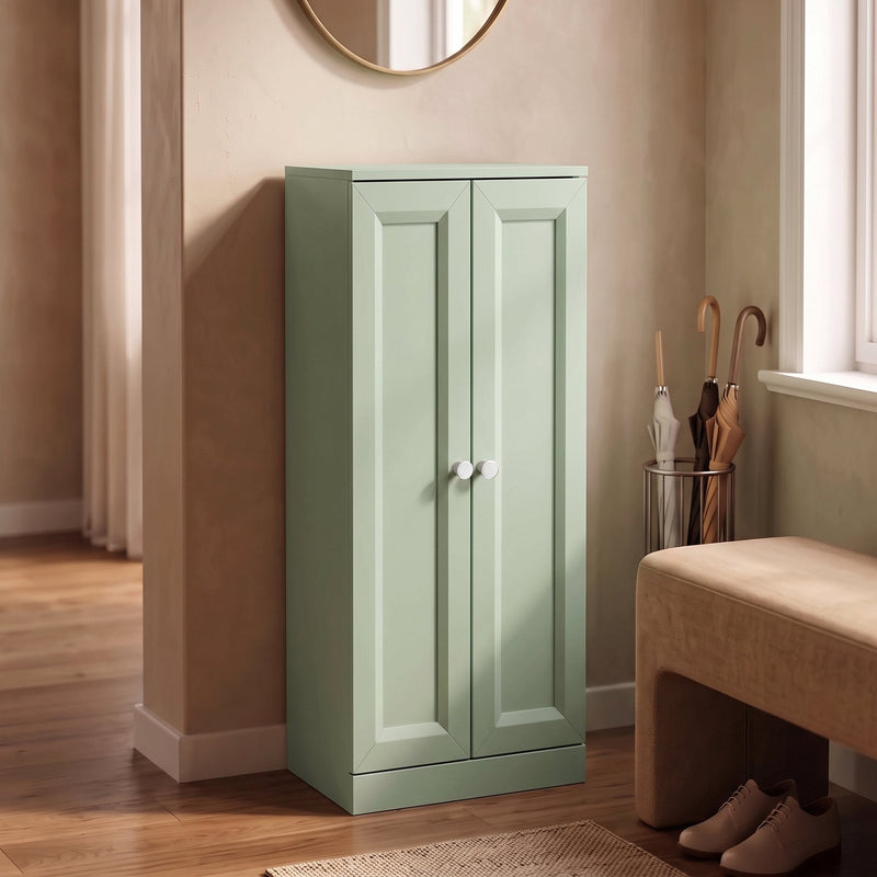 Light green bathroom cabinet in a hallway entryway next to an umbrella stand and bench
