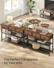 Two narrow console tables placed behind a sofa in a living room
