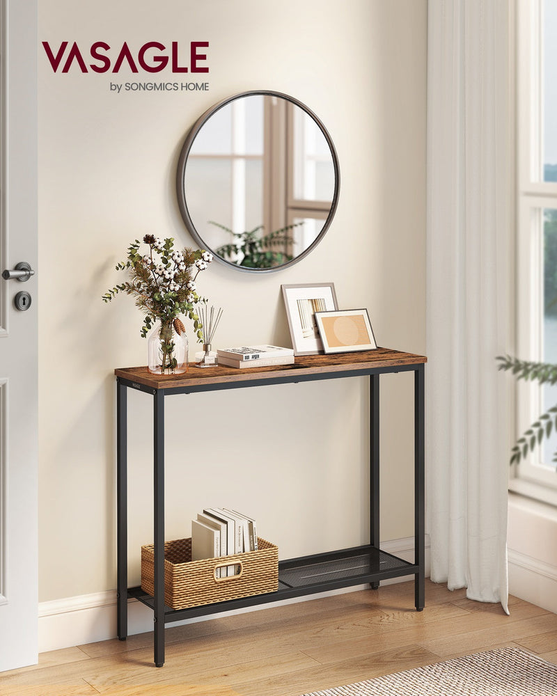 Rustic brown console table against a hallway wall below a round mirror, with a woven basket of books on the mesh shelf