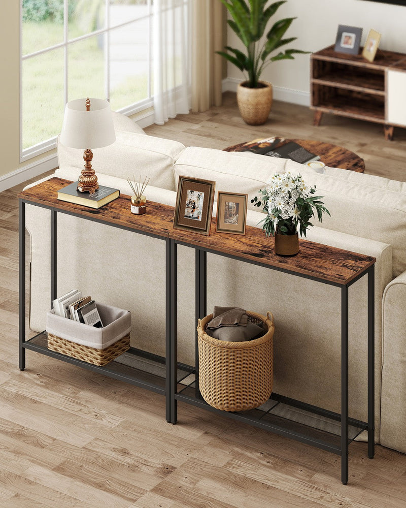 Two of the console tables lined up behind a cream sofa in a living room, holding a lamp, photo frames and storage baskets