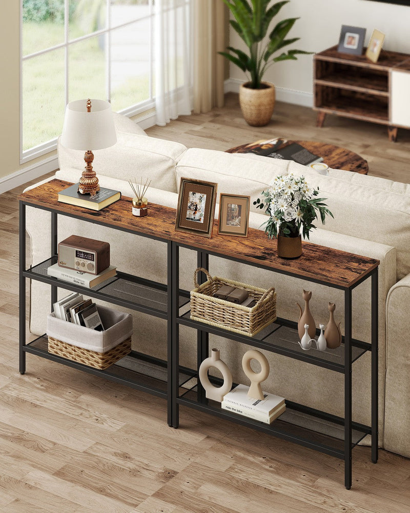 Two console tables placed together behind a sofa in a living room setting