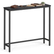 Black narrow steel console table with black wood-grain top, wallet, keys, notebooks and a small plant on top