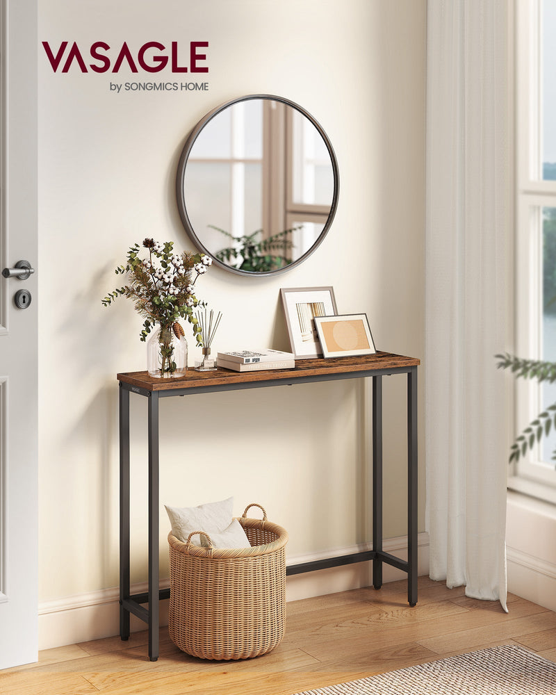 Rustic brown narrow console table in a hallway beneath a round mirror with a woven basket underneath