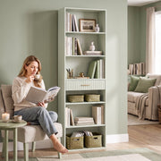 Light green bookcase in a living room beside a woman reading with a coffee
