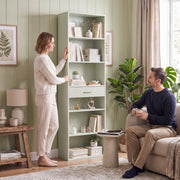 Light green bookcase in a living room with a couple relaxing nearby