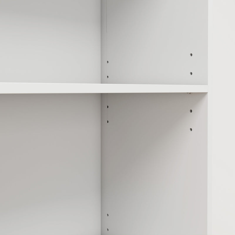 Close-up of an adjustable shelf and the shelf pin holes inside the white bookcase