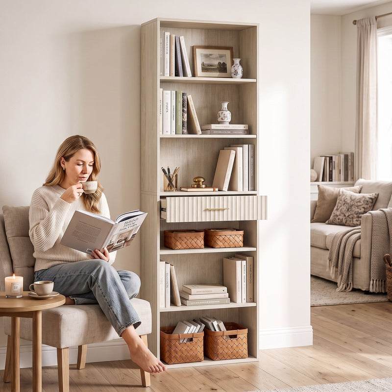 Oak wood effect bookcase styled in a living room reading corner with storage baskets