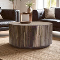 Natural bamboo inlay round coffee table with sunburst top in a bright living room