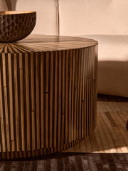 Overhead lifestyle view of the sunburst bamboo top with books and a vase