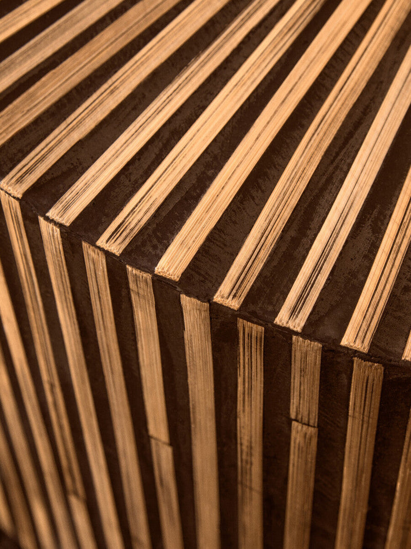 Round bamboo coffee table anchoring a family seating area