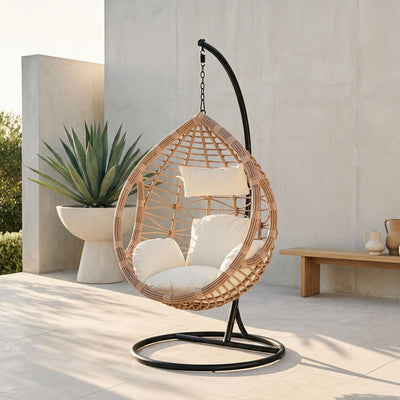 Natural rattan hanging chair shown in an outdoor patio setting