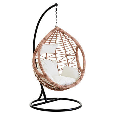 Natural rattan effect hanging chair with cream cushion, plain background