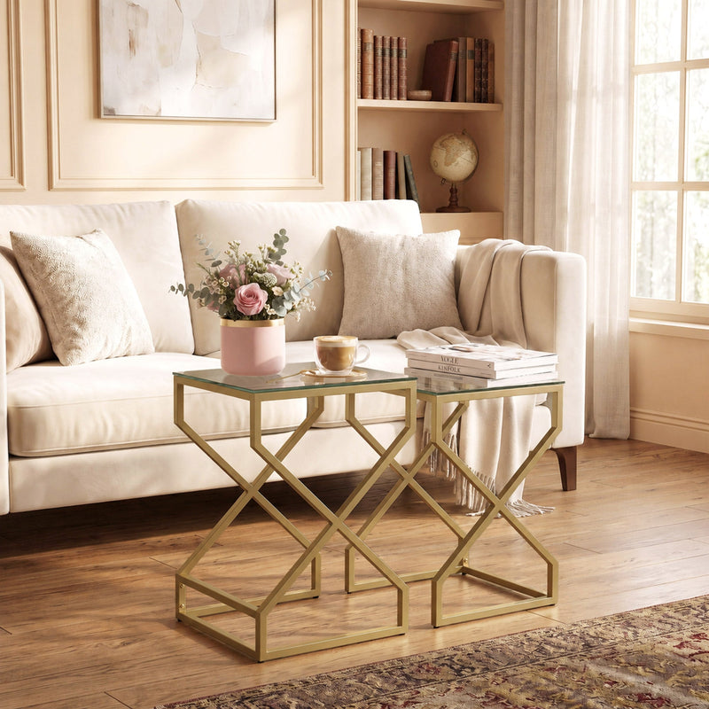 Nesting tables styled beside a sofa with flowers, coffee cup and magazines