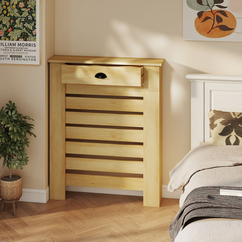 Radiator cover styled in a bedroom beside a bed and potted plant