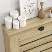 Close-up of the drawer handle and wood-grain tabletop surface with decorative ornaments