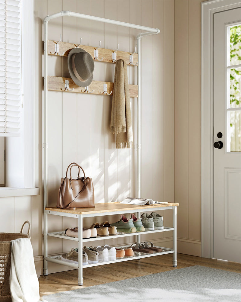 Coat rack stand in a hallway entryway beside a front door with shoes on the shelves