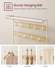 Close-up of the hanging rail and hooks holding hangers, umbrellas and a scarf