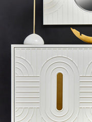 Off-white sideboard with black base and gold accents in a lifestyle setting