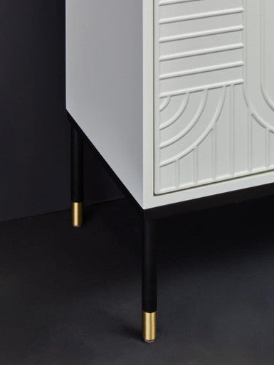 Off-white sideboard with black base and gold accents in a lifestyle setting