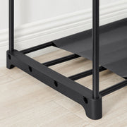 Close-up of the black plastic foot and lower frame bar on a wooden floor