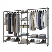 Black open wardrobe filled with hanging coats and shirts, folded clothes, shoes and storage boxes