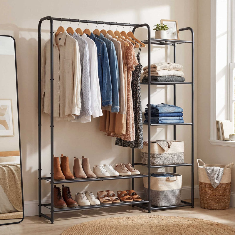 Clothes rack by a window with shirts hanging and woven baskets on the side shelves