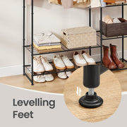 Close-up of an adjustable levelling foot beneath the loaded clothes rack