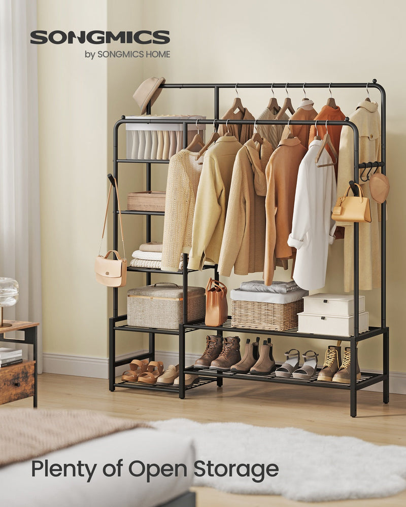 Clothes rack shown in a bedroom holding hanging garments