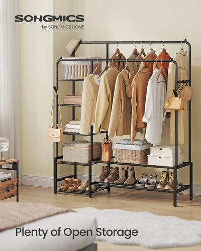 Clothes rack shown in a bedroom holding hanging garments