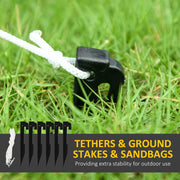 Black ground stake with white rope tether in grass beside six stakes