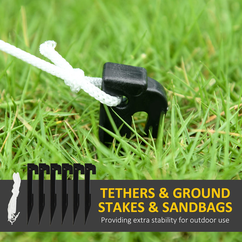 Black ground stake with white rope tether in grass beside six stakes