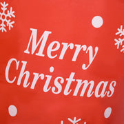 Red fabric close-up printed with Merry Christmas text and snowflakes