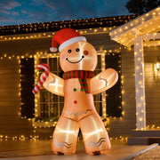 Lit inflatable gingerbread man in front of a house with fairy lights at dusk