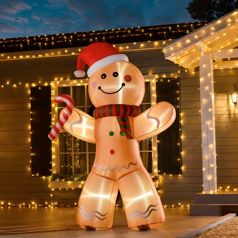 Lit inflatable gingerbread man in front of a house with fairy lights at dusk
